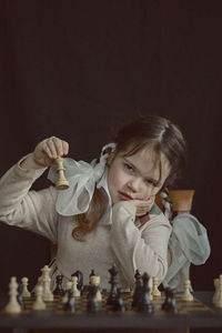 Cute girl playing chess