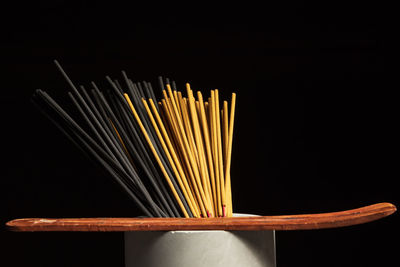 Close-up of chopsticks against black background