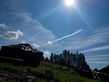 Scenic view of vapor trails against sky on sunny day