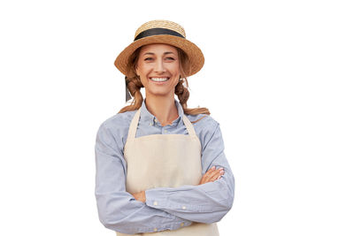 Portrait of a smiling young woman against white background