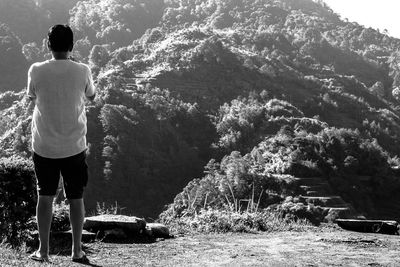 Rear view of man standing on mountain