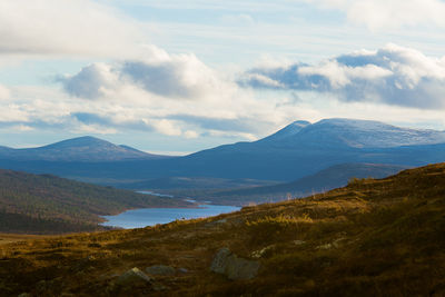 Scenic view of lake and mountains against sky