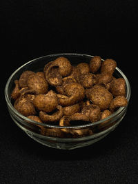 Close-up of cake in bowl on table against black background
