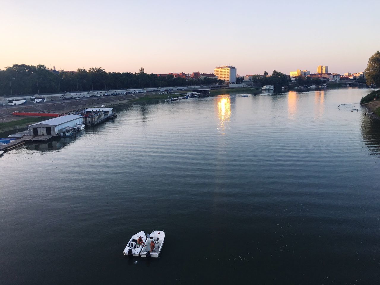 building exterior, built structure, architecture, sunset, water, clear sky, river, outdoors, bridge - man made structure, sky, nature, city, no people, nautical vessel, day, tree