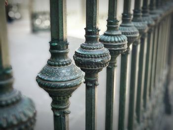 Close-up of antique metal railing against church building in square