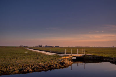 Scenic view of field against sky during sunset