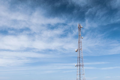 Low angle view of communications tower against sky