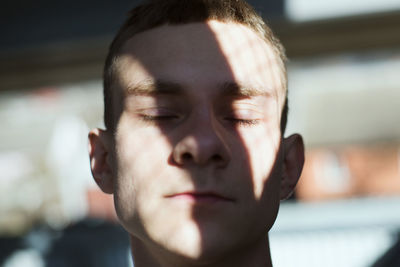 Close-up of young man with eyes closed