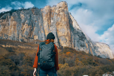 Rear view of man standing on rock