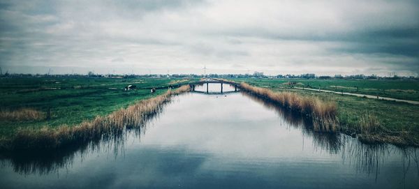 Bridge over canal against sky