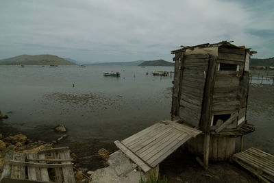 Abandoned built structure on beach against sky