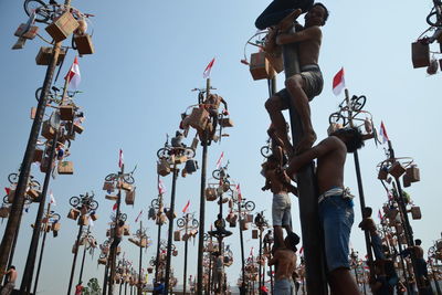 Low angle view of people against clear sky