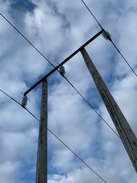 Low angle view of electricity pylon against sky