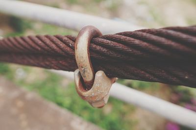 Close-up of rusty padlock on ropes