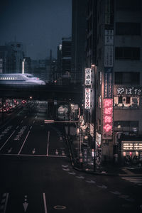 Illuminated city street and buildings at night