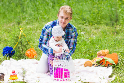 Portrait of happy man sitting in basket