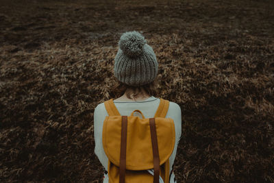 Rear view of boy standing on field