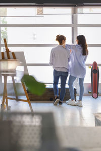 Rear view of people walking on floor