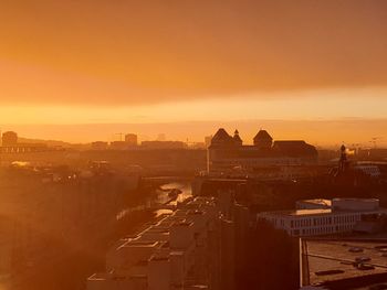 High angle view of buildings in town during sunset