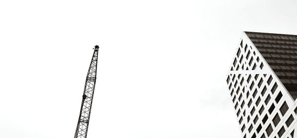 Low angle view of crane against clear sky