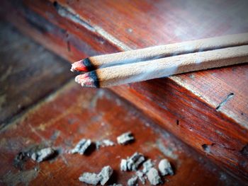 High angle view of cigarette on wood