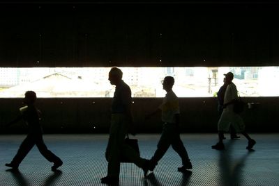 Silhouette people standing in corridor