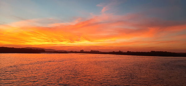 Scenic view of sea against romantic sky at sunset