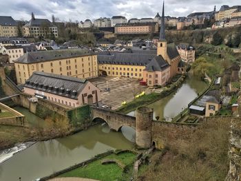 High angle view of old buildings by river in city