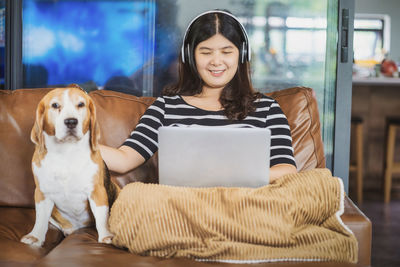 Portrait of young woman with dog