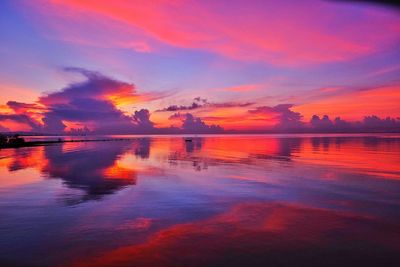 Reflection of clouds in sea at sunset