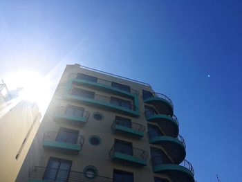 Low angle view of modern building against blue sky