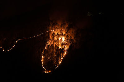 High angle view of firework display at night