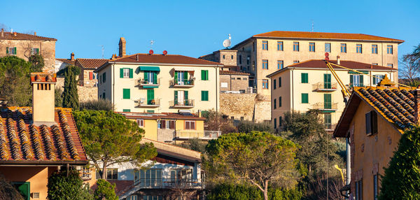 Buildings in city against blue sky