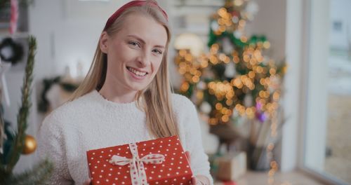 Portrait of young woman holding gift