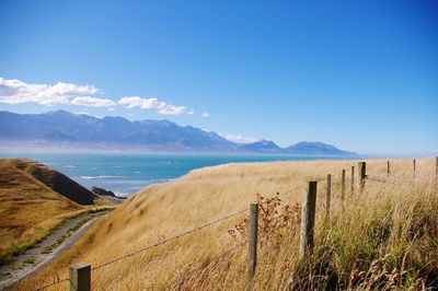 Scenic view of mountains against blue sky