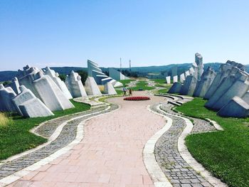 Panoramic view of footpath against clear blue sky