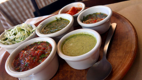 Close-up of various dips in bowls on table