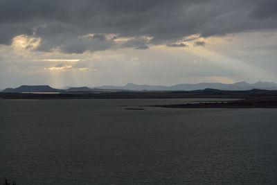 Scenic view of mountains against cloudy sky