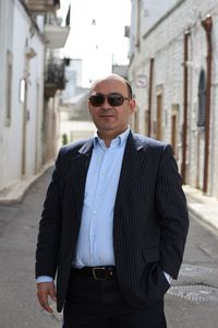 Portrait of man wearing sunglasses standing in city