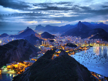 Aerial view of illuminated town against sky at night