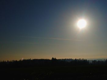 Scenic view of silhouette field against clear sky during sunset