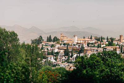 Houses in town against clear sky