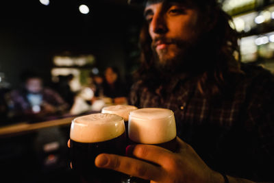 Bartender holding beer glasses