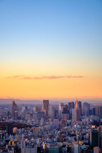 Modern buildings against sky during sunset