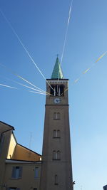 Low angle view of windmill against clear blue sky