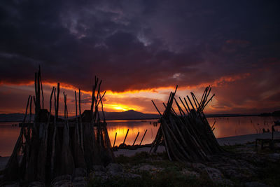 Scenic view of sea against dramatic sky during sunset