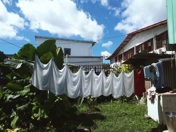 Clothes drying on clothesline against building