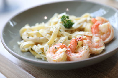 Close-up of pasta served in plate on table