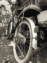 Bicycle parked by wall in city