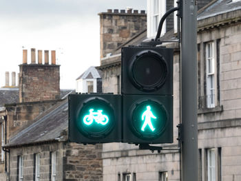 Close-up of road sign against built structures